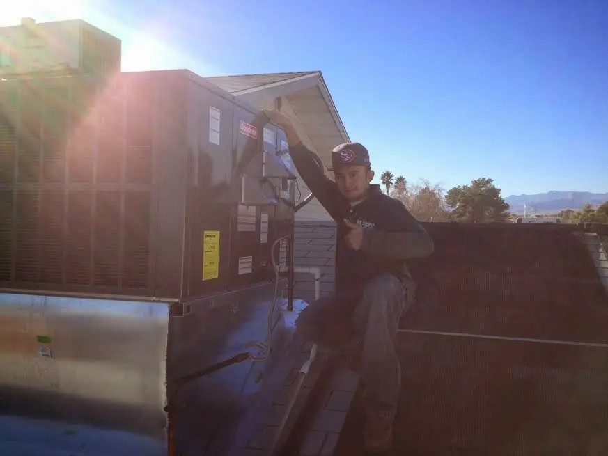HVAC technician performing HVAC Inspection on a rooftop unit in Polk City